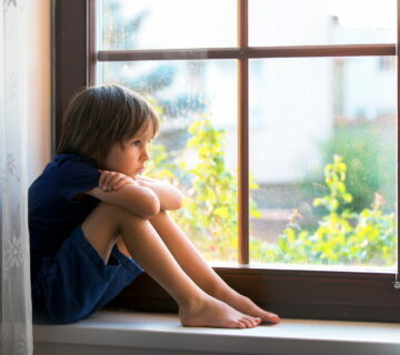 Child with ASD looking out of the window