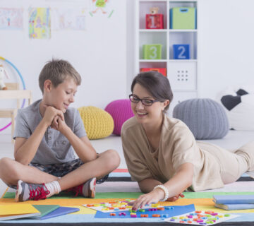 Child playing on a mat during an in-home ABA therapy session in Nebraska