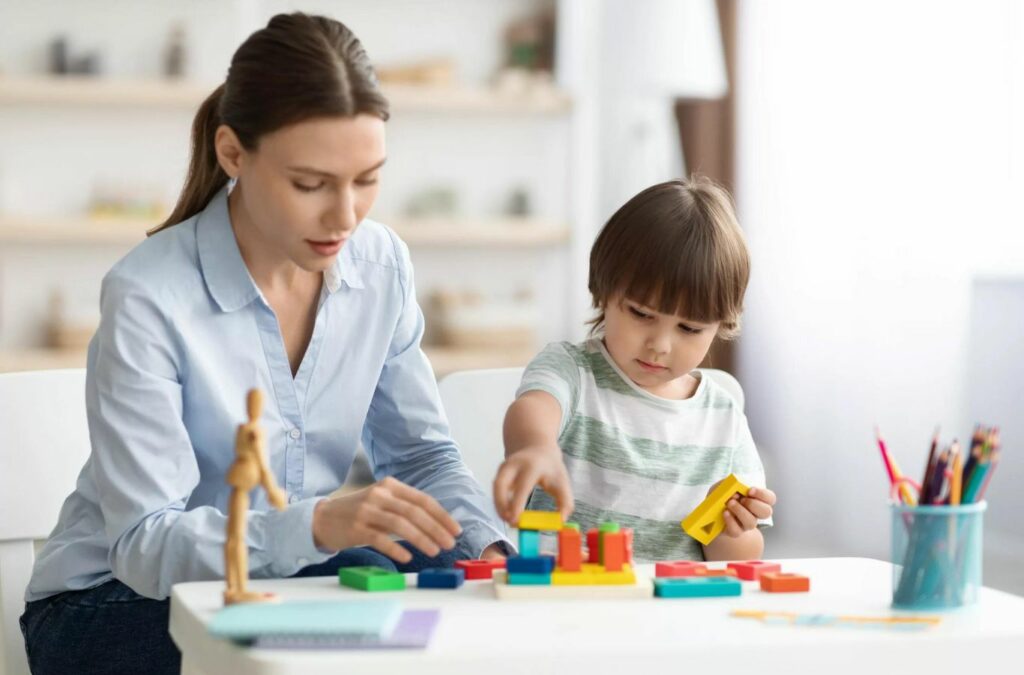 An ABA therapist from Kids Club ABA working with a child in Chattahoochee Hills, GA, providing personalized therapy to support their developmental growth.