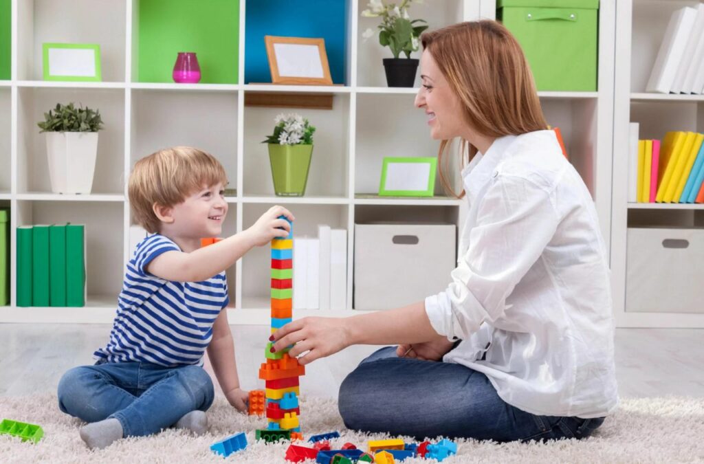 An ABA therapist from Kids Club ABA guiding a child through therapy exercises in Chattahoochee Hills, GA. ABA Therapy Near Me.