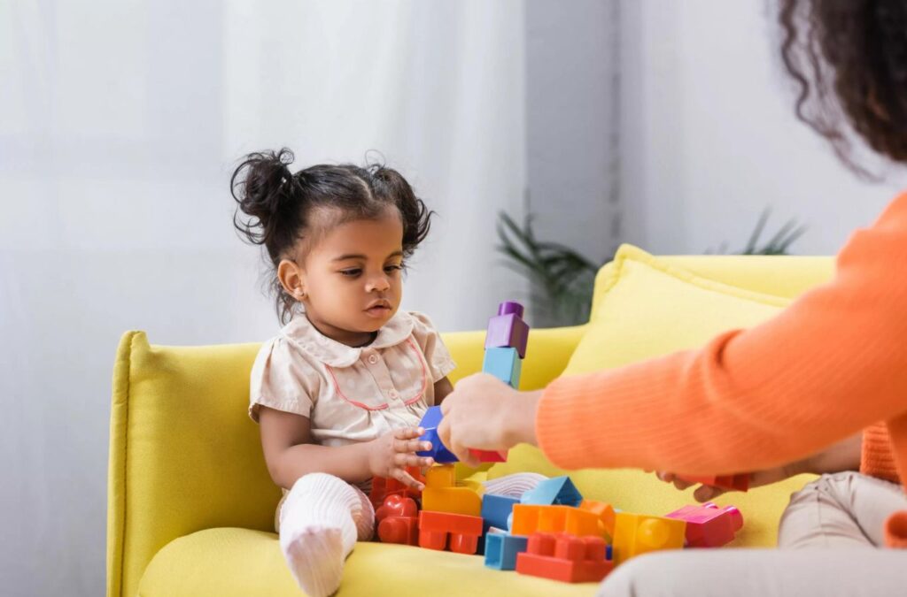 ABA Therapy in Hapeville, GA by Kids Club ABA - Caring therapist guiding a child through a personalized session.