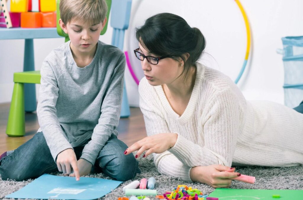 A Kids Club ABA therapist working with parents in Union City, GA, showing the benefits of family-supported care.