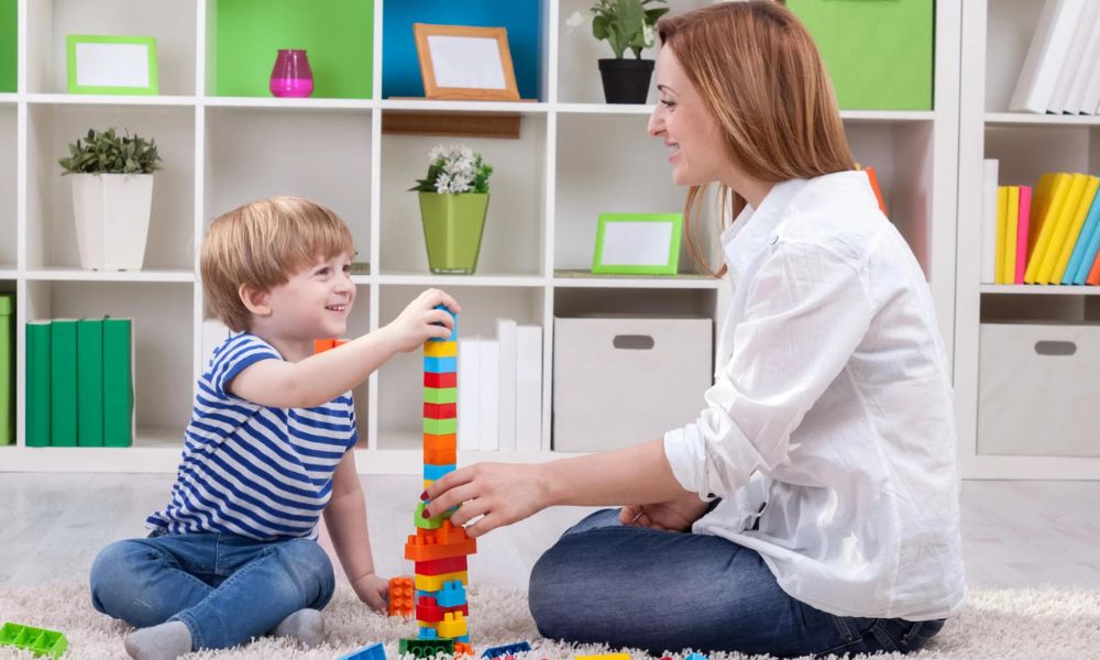 A therapist working one-on-one with a child during an ABA therapy session in an Atlanta clinic, focusing on communication and social skills development.