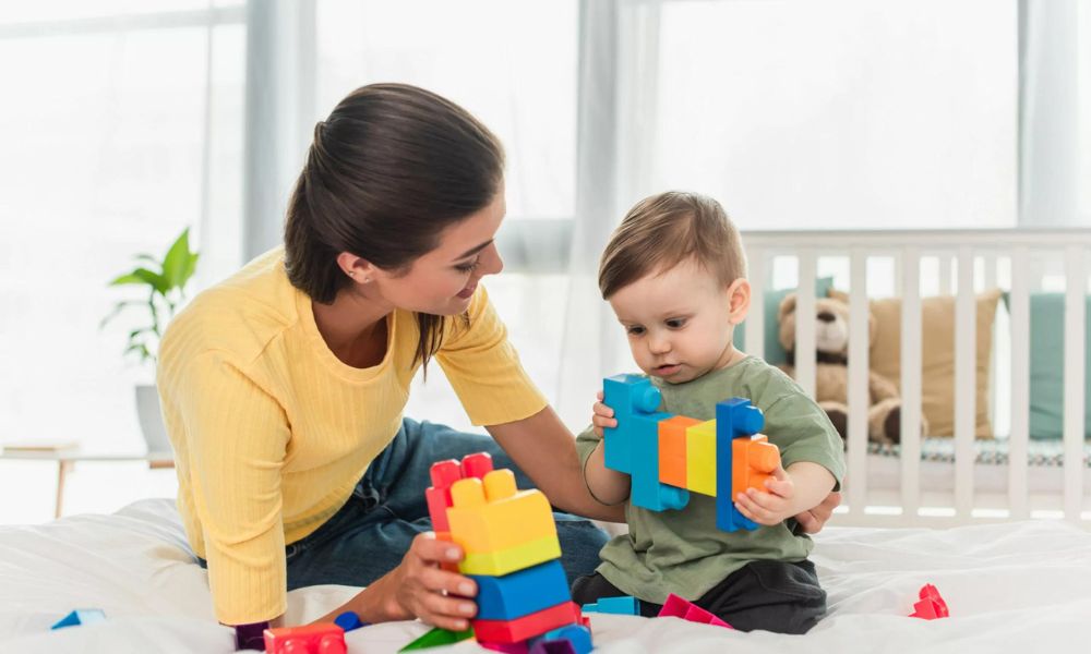 An ABA therapist working with a young child with autism at a therapy center in Atlanta, helping the child build communication and social skills.