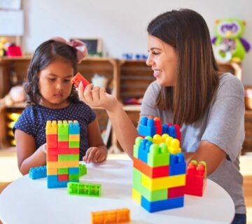 A child with autism working with a therapist on ABA activities in a supportive setting in Atlanta.