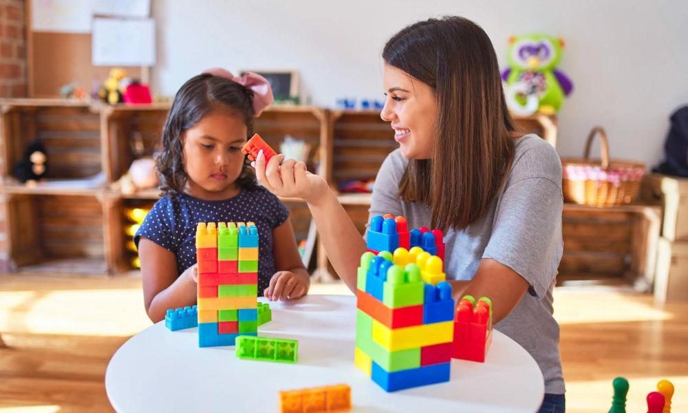 A child with autism working with a therapist on ABA activities in a supportive setting in Atlanta.