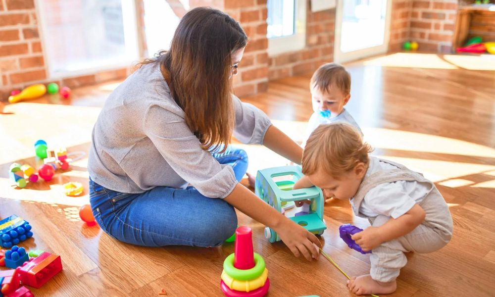 A parent sitting with a therapist and child during an ABA therapy session, actively participating and encouraging positive behaviors.