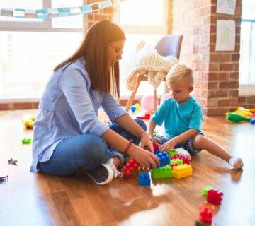 A calm, organized home therapy area with a child and therapist working together during an ABA session.