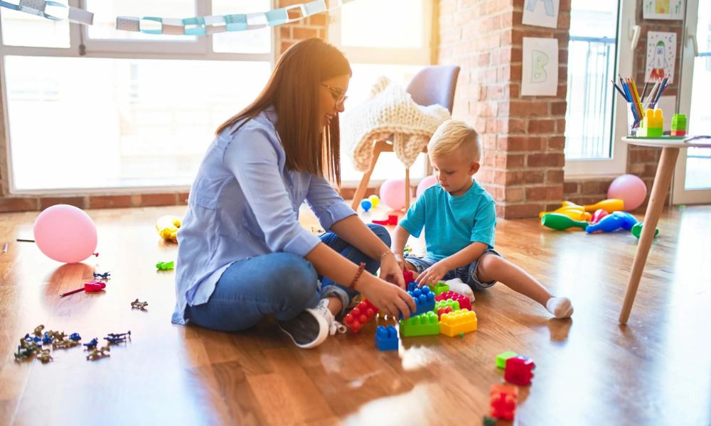 A calm, organized home therapy area with a child and therapist working together during an ABA session.