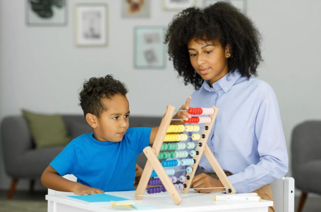 A Kids Club ABA therapist engaging in a one-on-one ABA therapy session with a child in Garden City, GA, demonstrating personalized care and support.